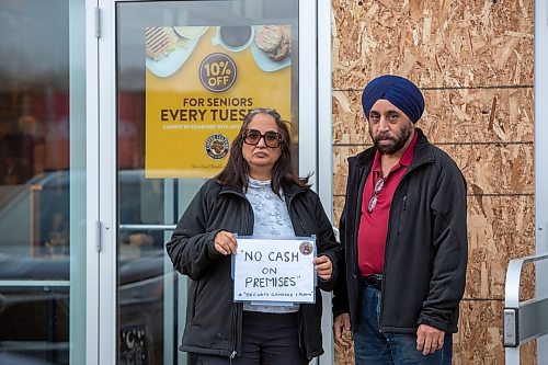 BROOK JONES / WINNIPEG FREE PRESS
The Coffee Culture Caf&#xe9; and Eatery at 2864 Pembina Highway in Winnipeg, Man., was broken into Sunday, Nov. 5, 2023. PIctured: Co-owners Sandeep Mehendiratta (left) and her husband Paramjeet Mehendiratta stand next to the doorlight which was broken at their caf&#xe9; and eatery in Winnipeg, Man., Wednesday, Nov. 8, 2023. Sandeep is holding a sign that reads &quot;No cash on premises&quot; and &quot;Security cameras &amp; alarms.&quot;