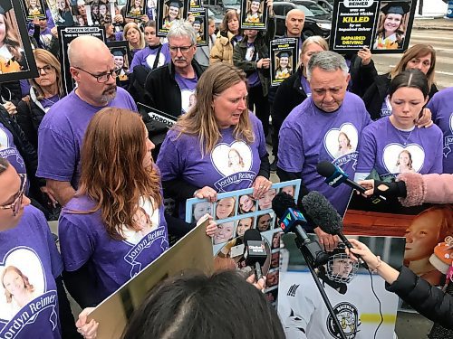 Jordyn Reimer's parents speak to reporters outside court on Friday.  Nearly 80 of Reimer’s friends and family members, all wearing purple “Justice for Jordyn” t-shirts, filled the gallery Friday as victim-impact statements were read at the sentencing hearing for Tyler Goodman. (Dean Pritchard / Winnipeg Free Press)