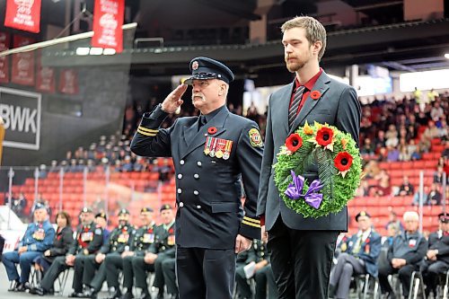 Capt. Doug Wheatland, left, and Firefighter-Paramedic Carter Thiessen lay a wreath at the Remembrance Day cenotaph on behalf of Brandon Fire & Emergency Services on Saturday morning at the Keystone Centre. (Matt Goerzen/The Brandon Sun)