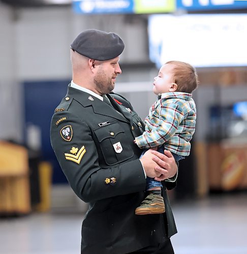 Master Cpl. Ryan Sandve, a Sig Opp with the Royal Canadian Corps of Signals, holds his one-year-old son Sawyer while watching Brandon's Remembrance Day ceremony on Saturday at the Keystone Centre. (Matt Goerzen/The Brandon Sun)