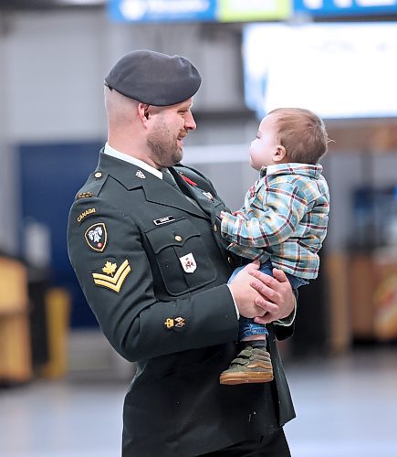 Master Cpl. Ryan Sandve, a Sig Opp with the Royal Canadian Corps of Signals, smiles at his one-year-old son Sawyer while watching Brandon's Remembrance Day ceremony on Saturday at the Keystone Centre. (Matt Goerzen/The Brandon Sun)
