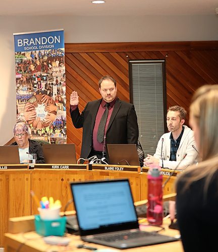 Kirk Carr is sworn in as Ward 1 school trustee at the Brandon School Division School Board special meeting on Monday. (Kyla Henderson/The Brandon Sun)