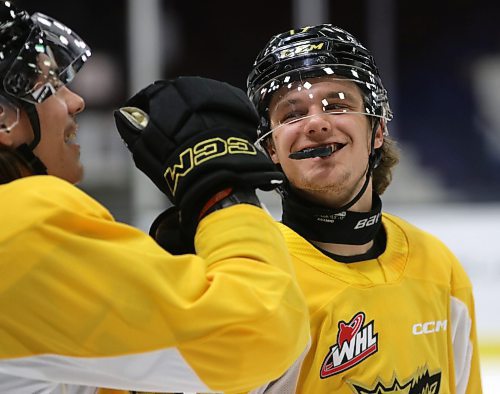 Brandon Wheat Kings rookie forward Joby Baumuller smiles at teammate Matt Henry during practice at Westoba Place on Tuesday. It was his first day back with the team after earning gold at the World U17 Hockey Challenge in Prince Edward Island. (Perry Bergson/The Brandon Sun)