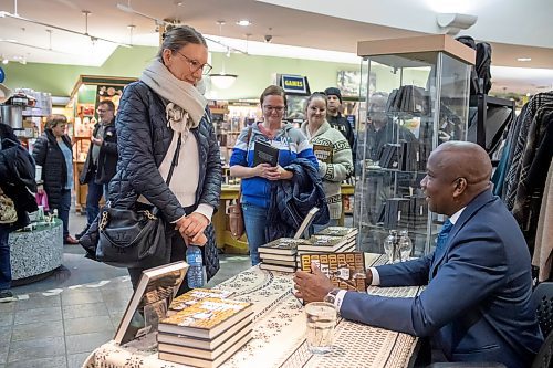 BROOK JONES / WINNIPEG FREE PRESS
Donovan Bailey (right) signing an autograph for Winnipeg resident Johanna Petkau, 43, at his book launch at McNally Robinson in Winnipeg, Man., Wednesday, Nov. 15, 2023. An Evening with Donovan Bailey was hosted by 103.1 Virgin Radio personality Ace Burpee. Bailey, who is an Olympian in the sport of athletics (track &amp; field) and won double gold at the 1996 Summer Olympic Games in Atlanta, Ga., was in Winnipeg promoting his book called Undisputed.