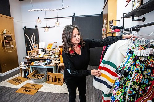 MIKAELA MACKENZIE / WINNIPEG FREE PRESS

Shauna Fontaine, owner of Anishinaabe Girl, shows a capote in the new store (which features the work of many Indigenous makers) on Lilac Street on Thursday, Nov. 16, 2023. For Gabby story.
Winnipeg Free Press 2023.