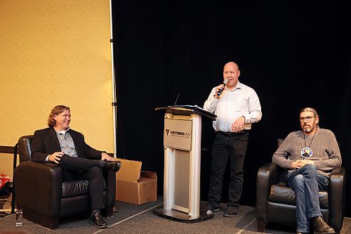 Brandon Fire and Emergency Services Chief Terry Parlow (centre) uses his expertise to burn Mayor Jeff Fawcett (left) during the Crossing the Line fundraiser for the John Howard Society of Brandon's transitional housing project at the Victoria Inn on Thursday evening. (Colin Slark/The Brandon Sun)