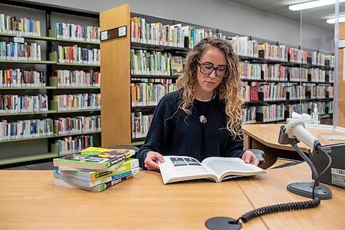 BROOK JONES / WINNIPEG FREE PRESS
St. James-Assinniboia Public Library branch head librarian Stephanie George is pictured looking at books while working at the reference desk on the second floor of the local library in Winnipeg, Man., Tuesday, Nov. 7, 2023.