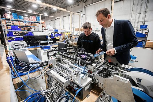 JOHN WOODS / WINNIPEG FREE PRESS
Adam Schmidt, president and founder of Activate, right, is photographed in his warehouse and manufacturing facility in Winnipeg Sunday, November  20, 2023. 

Reporter: gabby