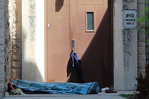RYAN THORPE / WINNIPEG FREE PRESS     



A man, identity unknown, sleeping outside the side entrance of All Saints Anglican Church in West Broadway on Monday afternoon, where a &quot;tent city&quot; has popped up over the past two weeks.May 28, 2018
