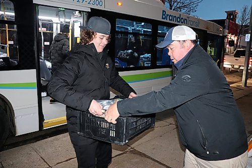 Members of the U15 AAA Brandon Wheat Kings hockey team help the Brandon-Westman Christmas Cheer board unload the donations they received during Saturday's Fill the Bus food drive. These non-perishable food items are currently being stored at the Christmas Cheer board's downtown office in preparation for their distribution of holiday hampers in December. (Kyle Darbyson/The Brandon Sun)