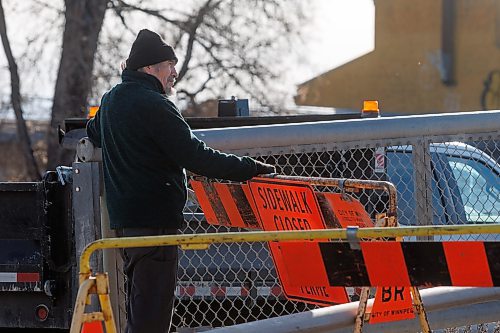 MIKE DEAL / WINNIPEG FREE PRESS
Virgil Mason watches City of Winnipeg crews install barriers on the North end of the Arlington Street Bridge. The bridge which opened in 1912, has been closed indefinitely. 
Virgil lives in the area North of the Arlington Street Bridge and would walk across it for exercise a number of times a day.
231122 - Wednesday, November 22, 2023.