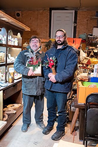 BROOK JONES / WINNIPEG FREE PRESS
Bill Gidzak, 67, and his son Nick, 42, run a woodworking shop called Artisanal Firewood. The father-and-son team turn out a variety of products, especially Christmas theme decorations and toys for kids. Pictured: Bill (right) and Nike holding Christmas decorations they've made through woodworking inside Bill's garage at his home in Winnipeg, Man., Wednesday, Nov. 22, 2023.
