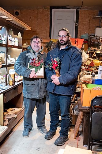 BROOK JONES / WINNIPEG FREE PRESS
Bill Gidzak, 67, and his son Nick, 42, run a woodworking shop called Artisanal Firewood. The father-and-son team turn out a variety of products, especially Christmas theme decorations and toys for kids. Pictured: Bill (right) and Nike holding Christmas decorations they've made through woodworking inside Bill's garage at his home in Winnipeg, Man., Wednesday, Nov. 22, 2023.