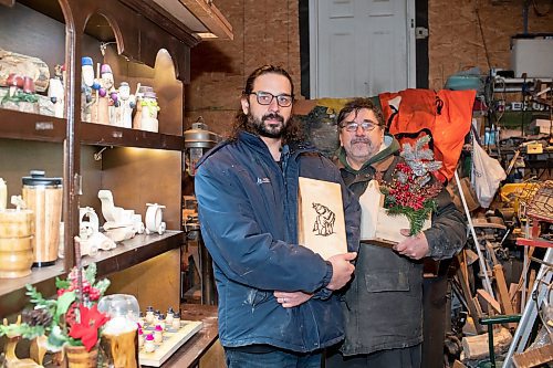 BROOK JONES / WINNIPEG FREE PRESS
Bill Gidzak, 67, and his son Nick, 42, run a woodworking shop called Artisanal Firewood. The father-and-son team turn out a variety of products, especially Christmas theme decorations and toys for kids. Pictured: Nick (left) and Bill holding items they've made through woodworking inside Bill's garage at his home in Winnipeg, Man., Wednesday, Nov. 22, 2023.