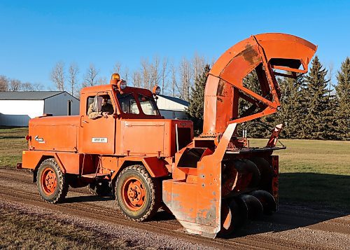 Harley Lumb's orange 1956 Sicard Snowmaster Junior snow blower truck with the chute extended, west of Brandon. (Michele McDougall/The Brandon Sun)