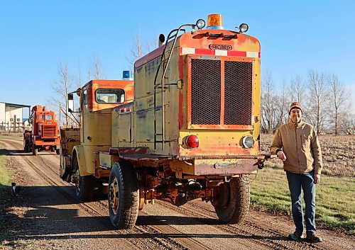 Harley Lumb stands next to his yellow 1957 Sicard Snowmaster Senior snow blower truck, with his orange 1956 Sicard Snowmaster Junior snow blower truck in the background, west of Brandon. (Michele McDougall/The Brandon Sun)