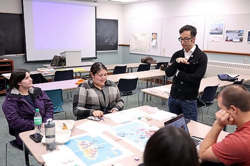 22112023
Brandon University Political Science students Jessica Redekopp, Karleen Anderson, Marlina O’Nions and Matthew Reimer take part in a China-Taiwan tensions wargame on Wednesday evening as part of Chris Hunt’s (standing) Strategies of Major Powers class. The wargame concludes next Wednesday evening. 
(Tim Smith/The Brandon Sun)