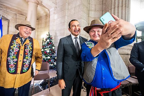 MIKAELA MACKENZIE / WINNIPEG FREE PRESS

Premier Wab Kinew (centre) and MMF president David Chartrand (left) take a selfie with MMF minister Richard Genaille after announcing the introduction of legislation naming Louis Riel as the honourary first premier of Manitoba at the legislative building on Thursday, Nov. 23, 2023. For Danielle story.
Winnipeg Free Press 2023.