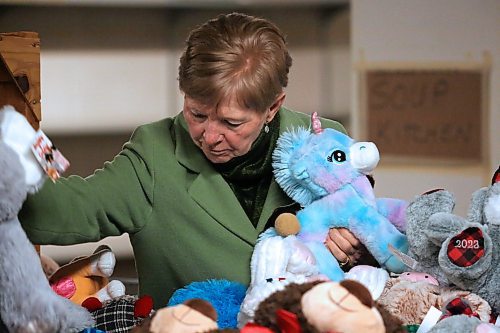 Nancy DeRoo with Knox United Church searches through extra plush toys at the Brandon-Westman Christmas Cheer Board office on Rosser Avenue to help fill 22 holiday hampers being offered through the church. (Matt Goerzen/The Brandon Sun)