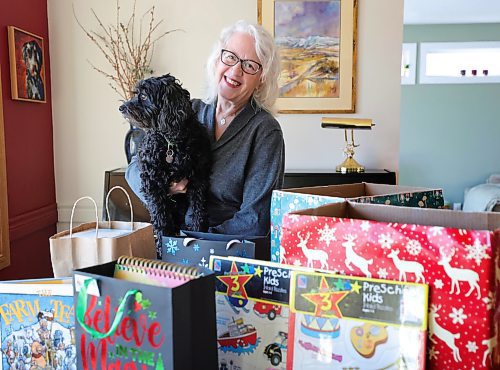 RUTH BONNEVILLE / WINNIPEG FREE PRESS

Christmas Cheer Board

Portrait of Carol Frampton with her open hampers she is beginning to fill on her dining room table Friday.  Carol Frampton  a longtime sponsor of the Feed-A-Family program and heads four different sponsorship groups. 

Her dog, Ollie, likes to be a part of stocking hampers.  

See story by Josh

Nov 24th,, 2023