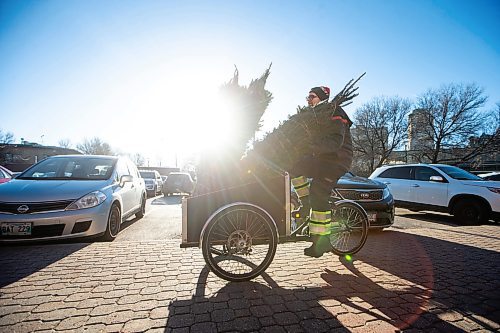 MIKAELA MACKENZIE / WINNIPEG FREE PRESS

Garrett Everett with Winnipeg Trails transports balsam firs from storage to the Christmas Tree stand using a cargo bike at The Forks on Friday, Nov. 24, 2023. All of the proceeds from the sale, which starts today, are going towards the Future Forest initiative (which plants trees along trails in Winnipeg and surrounding areas). Standup.
Winnipeg Free Press 2023.