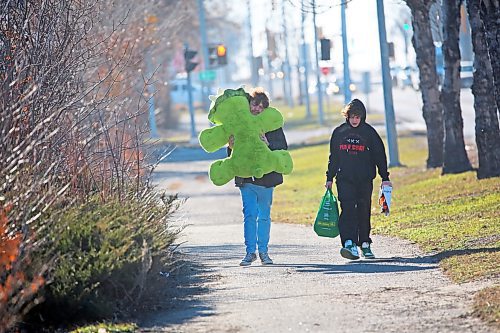 Brothers Finlay Lecheminant and Orson Lecheminant walk home along 18th Street with gifts after a morning of Christmas shopping on Friday. (Matt Goerzen/The Brandon Sun)