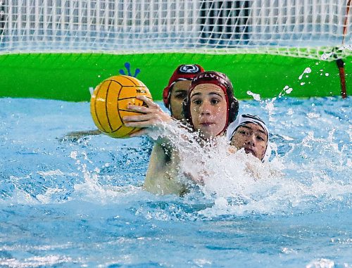 JOHN WOODS / WINNIPEG FREE PRESS
Kelvin High School&#x2019;s Jacob Carranza (4) takes the backhander against Vincent Massey Collegiate&#x2019;s goaltender Mattias Mukozi (1) as Zander Vernon (9) defends in the Manitoba Schools Water Polo League gold medal game at the Pan Am pool in Winnipeg Sunday, November  26, 2023. Vincent Massey went on to win the championship game.

Reporter: Josh