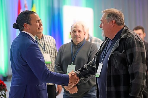 RM of St. Anne Coun. Brad Ingles shakes hands with Manitoba Premier Wab Kinew following the premier's speech at the opening day of the Association of Manitoba Municipalities conference in Brandon on Tuesday afternoon. (Matt Goerzen/The Brandon Sun)