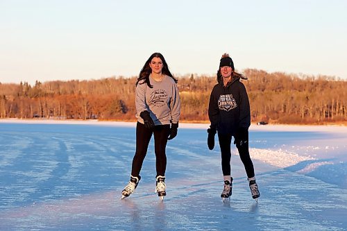 28112023
Friends Alexandria Singh and Shelby Hynes ice skate together on a cleared trail along the western side of Minnedosa Lake at sunset on a sunny and mild Tuesday. 
(Tim Smith/The Brandon Sun)