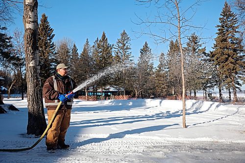 28112023
Lance McKay with Parks Canada floods a pathway for the skating trail at Riding Mountain National Park in Wasagaming on a sunny and mild Tuesday. 
(Tim Smith/The Brandon Sun)