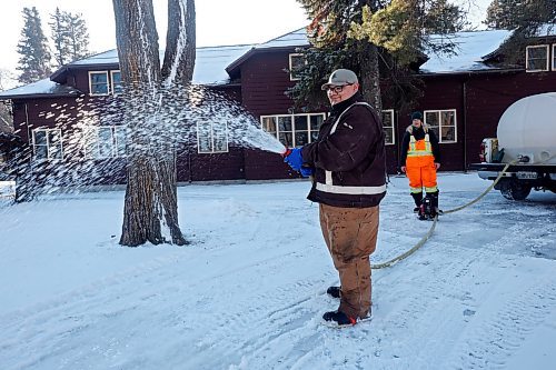 28112023
Lance McKay and Shanda Wruth with Parks Canada flood a pathway for the skating trail at Riding Mountain National Park in Wasagaming on a sunny and mild Tuesday. 
(Tim Smith/The Brandon Sun)