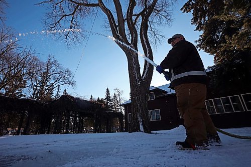 28112023
Lance McKay with Parks Canada floods a pathway for the skating trail at Riding Mountain National Park in Wasagaming on a sunny and mild Tuesday. 
(Tim Smith/The Brandon Sun)