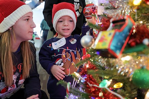 RUTH BONNEVILLE / WINNIPEG FREE PRESS

LOCAL STDUP - Trees of Joy, Make-A-Wish  

Make-A-Wish Canada hosts the 2nd Annual Trees of Joy fundraising campaign with 14 sponsored trees for 14 wish kids at the Gates on Wednesday.  

Photo of Seth Lafond (8yrs), with his sister, Sadie, as they look at his tree of Joy Wednesday.  

The 14 corporate tree sponsors customized their tree with their child's specific interests in mind to spark joy in the child's heart as they hunted for their tree in a visually striking, holiday forest. 

The event was attended by the child's families, friends and sponsors to raise funds for children with critical illnesses to have their wishes come true  Each of the trees will be delivered to wish families&#x560;homes to enjoy throughout the holiday season and every tree will represent another wish granted to another child by a corporate partner.


Nov 29th,, 2023
