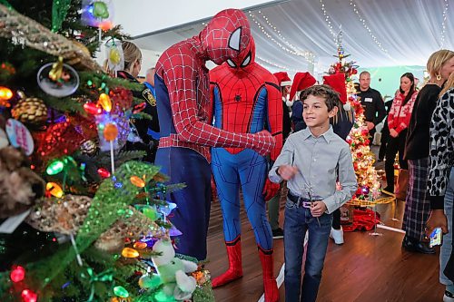 RUTH BONNEVILLE / WINNIPEG FREE PRESS

LOCAL STDUP - Trees of Joy, Make-A-Wish  

Make-A-Wish Canada hosts the 2nd Annual Trees of Joy fundraising campaign with 14 sponsored trees for 14 wish kids at the Gates on Wednesday.  

Photo of Tiago Moranda (10yrs) checking out his Tree of Joy with his favourite super hero, Spiderman x 2 , provided by Amazing Entertainment Wednesday.  

The 14 corporate tree sponsors customized their tree with their child's specific interests in mind to spark joy in the child's heart as they hunted for their tree in a visually striking, holiday forest. 

The event was attended by the child's families, friends and sponsors to raise funds for children with critical illnesses to have their wishes come true  Each of the trees will be delivered to wish families&#x560;homes to enjoy throughout the holiday season and every tree will represent another wish granted to another child by a corporate partner.


Nov 29th,, 2023