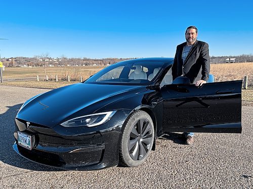 Chris Budiwski stands beside his and his wife Michelle's 2022 Tesla Model S Long Range. (Photos by Michele McDougall/The Brandon Sun)