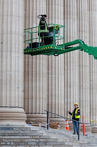 MIKE DEAL / WINNIPEG FREE PRESS
Curtis Demeyer (left) and Derek Morley (right) from Lights Unlimited installs strings of lights on the columns at the front of the Manitoba Legislative Building, a total of approximately 3500 bulbs, as part of the festive dressing up for the season and the open house which takes place on Saturday.
231130 - Thursday, November 30, 2023.