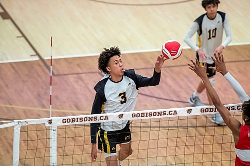 BROOK JONES / WINNIPEG FREE PRESS
The Dakota Lancers earned a 3-0 (25-16, 25-23, 25-23) victory over the Glenlawn Lions to capture the semifinal (final four) of the Boston Pizza AAAA Varisty Boys Volleyball Championships hosted by the Maintoba High Schools Athletic Association inside Investors Group Athletic Centre at the University of Manitoba Fort Garry campus in Winnipeg, Man., Thursday, Nov. 230, 2023.. With the win, the Lancers will compete in the MHSAAA provincial volleyball championships at IGAC Monday, Dec. 4, 2023. Pictured: Dakota Lancers oppostie Wizdom Smith (No. 3) taps the volleyball over the net as Glenlawn Lions setter Benjamin Doan (right) goes up for the block during third set action.