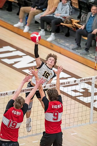 BROOK JONES / WINNIPEG FREE PRESS
The Dakota Lancers earned a 3-0 (25-16, 25-23, 25-23) victory over the Glenlawn Lions to capture the semifinal (final four) of the Boston Pizza AAAA Varisty Boys Volleyball Championships hosted by the Maintoba High Schools Athletic Association inside Investors Group Athletic Centre at the University of Manitoba Fort Garry campus in Winnipeg, Man., Thursday, Nov. 230, 2023.. With the win, the Lancers will compete in the MHSAAA provincial volleyball championships at IGAC Monday, Dec. 4, 2023. Pictured: Dakota Lancers setter Jhet Bowen (No. 16) spikes the volleyball over the net as Glenlawn Lions middle Tyler Field (No. 19)  and teammate right side Nico Nadeau (No. 9) prepare an attempt to block the ball during third set action.
