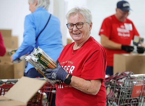 RUTH BONNEVILLE / WINNIPEG FREE PRESS

Local -  Christmas Cheerboard Story

Photo of longtime volunteer, Sheila Worboys, helping volunteers as they pack food hampers at the Christmas Cheer warehouse Thursday. 

Feature at the warehouse speaking to volunteers on the sense of community that they feel.
 
CHEER BOARD: Every year the Cheer Board sets up for the massive undertaking of receiving, building and sending out over 18,000 hampers to families in need. Before the phone lines even open, volunteers have already been busy for weeks building a functional warehouse space, receiving food, setting up different work areas. 

See TAYLOR'S Story. 

Nov 30th,, 2023