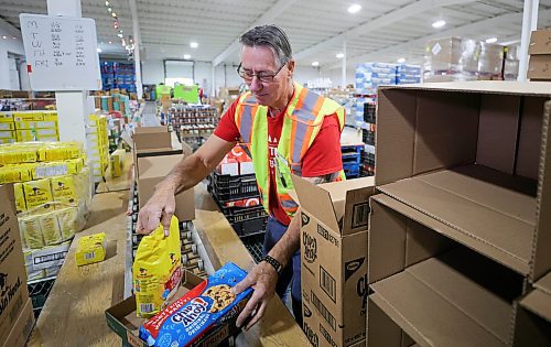 RUTH BONNEVILLE / WINNIPEG FREE PRESS

Local -  Christmas Cheerboard Story

Photo of longtime volunteer, Rick Gill, warehouse operations manager, setting up sample hampers Thursday. 

Feature at the warehouse speaking to volunteers on the sense of community that they feel.
 
CHEER BOARD: Every year the Cheer Board sets up for the massive undertaking of receiving, building and sending out over 18,000 hampers to families in need. Before the phone lines even open, volunteers have already been busy for weeks building a functional warehouse space, receiving food, setting up different work areas. 

See TAYLOR'S Story. 

Nov 30th,, 2023