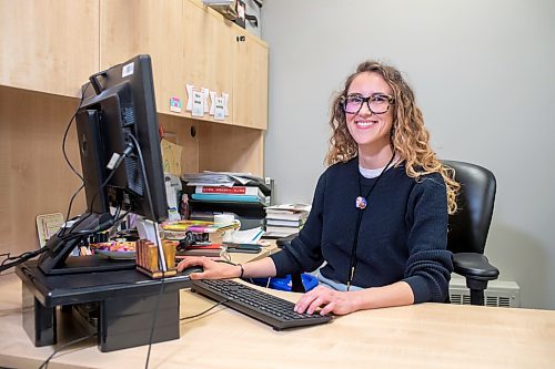BROOK JONES / WINNIPEG FREE PRESS
St. James-Assinniboia Public Library branch head librarian Stephanie George is pictured smiling while working at a desk in her office on the main floor of the local library in Winnipeg, Man., Tuesday, Nov. 7, 2023.