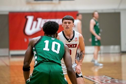 BROOK JONES / WINNIPEG FREE PRESS
The University of Winnipeg Wesmen play host to the visiting University of Saskatchewan Huskties in Canada West men's basketball action inside the Dr. David F. Anderson Gymnasium at the Duckworth Centre at the University of Winnipeg in Winnipeg, Man., Friday, Dec. 1, 2023. Pictured: Winnipeg Wesmen guard Kato Jaro (No. 0) guards Saskatchewan Huskies guard Fisayo Moibi (No. 10) during second quarter action.