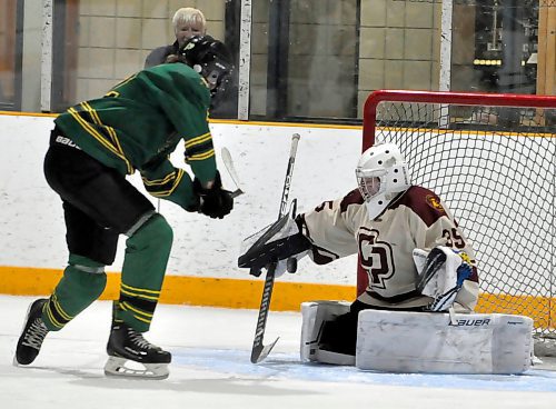 John Taylor Pipers forward Trenton Beaudoin (19) is stymied in close by Crocus Plainsmen goalie Shelby Brown during first period action Sunday afternoon at Enns Arena during the bronze medal game. Beaudoin did score twice later to pace his team to a 7-1 victory.
(Photo Jules Xavier/The Brandon Sun)