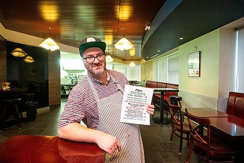 MIKAELA MACKENZIE / WINNIPEG FREE PRESS

Nick Graumann, chef/owner of Nick&#x2019;s on Broadway, at the restaurant on Tuesday, Dec. 5, 2023. Nick&#x2019;s on Broadway has a &#x201c;budget bites&#x201d; menu, where everything is around $4. The menu, made to attract customers, has gotten very popular. For Gabby story.
Winnipeg Free Press 2023