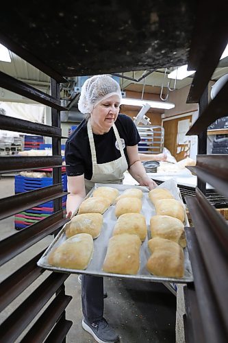 RUTH BONNEVILLE / WINNIPEG FREE PRESS

INTERSECTION - St.Pierre Bakery

Photo of staff member, Carol Fontaine  packaging up ciabatta buns with her co-workers.   

Joe Gagne, owner Boulangerie St-Pierre Bakery, in  St-Pierre-Jolys (about 30 minutes south of the Mint) 

Story: This is for an Intersection piece on the St-Pierre Bakery, which has been cranking out loaves of bread, cinnamon buns and tourtiere for close to a century. 

Joe, the present owner, took over from his parents a few years ago; his dad started working there in the '80s, and bought the bakery in 1992 (owner previous to the Gagnes, a fellow named Norm, had it from the mid-60s to the early '90s, 
(Photo of all three in the original building with staff working in the background)

They turn out as many as 1,800 loaves of bread an hour, it's a hopping place. Also photos of pastries, storefront - customers, workers and outside shot of building.  


See Dave's story. 

Dec 5th,  2023