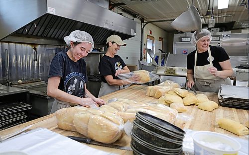 RUTH BONNEVILLE / WINNIPEG FREE PRESS

INTERSECTION - St.Pierre Bakery

Photo of staff members, Summer O'Reilly (left, Theresa Tanner and Carol Fontaine sharing some laughs while packaging up ciabatta buns.  

Joe Gagne, owner Boulangerie St-Pierre Bakery, in  St-Pierre-Jolys (about 30 minutes south of the Mint) 

Story: This is for an Intersection piece on the St-Pierre Bakery, which has been cranking out loaves of bread, cinnamon buns and tourtiere for close to a century. 

Joe, the present owner, took over from his parents a few years ago; his dad started working there in the '80s, and bought the bakery in 1992 (owner previous to the Gagnes, a fellow named Norm, had it from the mid-60s to the early '90s, 
(Photo of all three in the original building with staff working in the background)

They turn out as many as 1,800 loaves of bread an hour, it's a hopping place. Also photos of pastries, storefront - customers, workers and outside shot of building.  


See Dave's story. 

Dec 5th,  2023