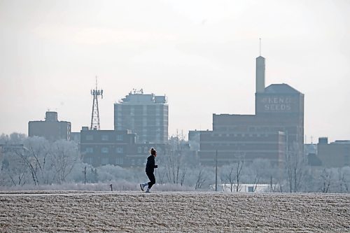 04122023
A runner out for a jog is framed by hoar-frost covered trees and the downtown Brandon skyline at the Riverbank Discovery Centre on Tuesday. (Tim Smith/The Brandon Sun)