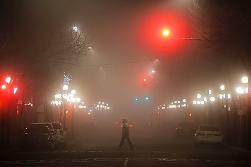 04122023
A pedestrian crosses Rosser Avenue amid thick fog on Monday evening. The fog led to hoar-frost throughout westman on Tuesday. (Tim Smith/The Brandon Sun)