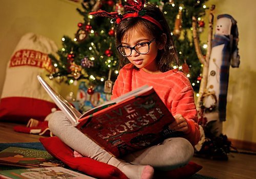 JOHN WOODS / WINNIPEG FREE PRESS
Faith reads some Christmas books at her home Tuesday, December 5, 2023. 

Reporter: ben - Christmas book front