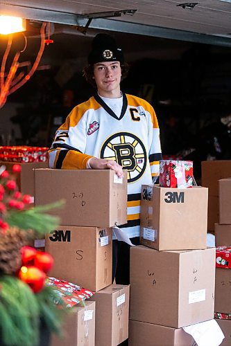 MIKAELA MACKENZIE / WINNIPEG FREE PRESS
	
Tyden Lafournaise with Christmas Cheer Board hampers ready to be delivered by him and his Winnipeg Bruins teammates this weekend on Friday, Dec. 8, 2023.
Winnipeg Free Press 2023